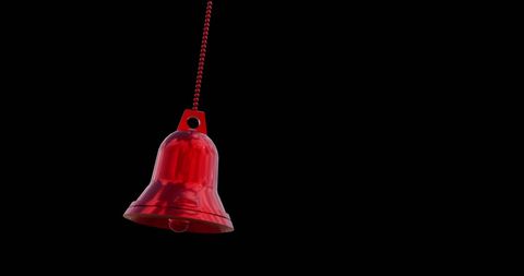 Red christmas bell decoration on black background