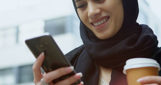 Smiling Middle Eastern Woman Checking Phone While Holding Coffee - Download Free Stock Images Pikwizard.com