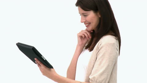 Woman Smiling While Using Tablet Against White Background