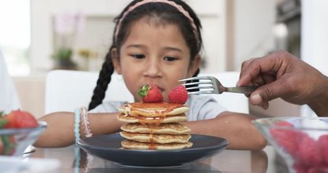 Biracial Girl Eagerly Looks at Delicious Pancakes - Download Free Stock Images Pikwizard.com