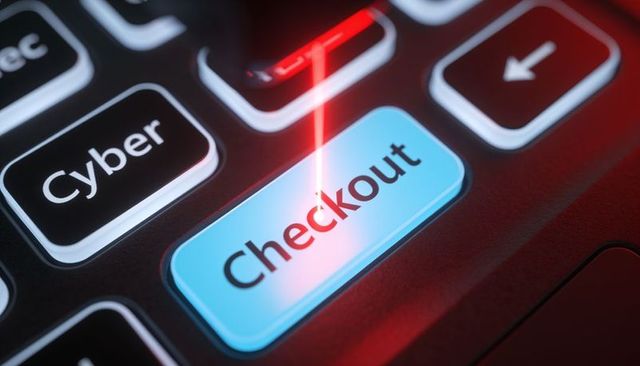 Red laser hitting checkout key on backlit keyboard highlighting e-commerce cyber risk