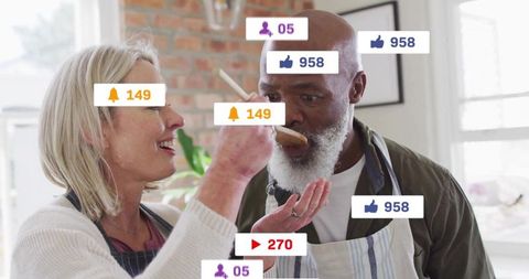 Mature couple cooking and tasting in bright kitchen with social media engagement overlays