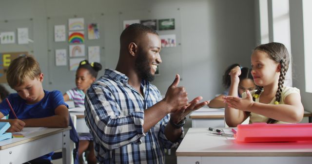 Image of happy african american teacher learning caucasian girl how to count in classroom. primary school education and teaching profession.