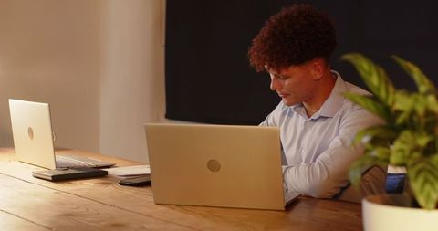 Businessman Working Late on Laptop in Office