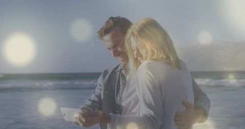 Romantic beach couple embracing with dreamy lighting