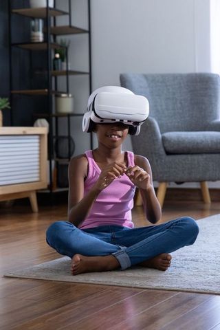 African american child exploring virtual reality with vr headset in cozy living room