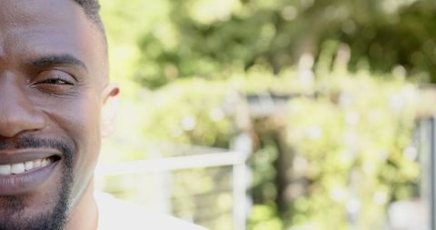 Joyful Man Smiling Outdoors on Sunny Day