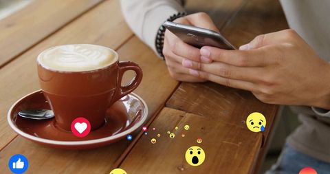 Connecting over coffee at café table with emoji trends