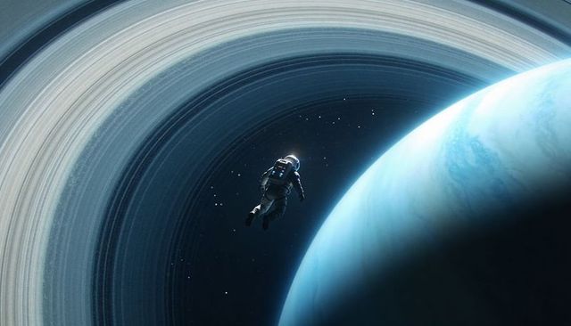 Solitary astronaut drifting beside colossal ringed gas giant, illuminated life support pack