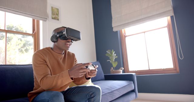 Man Gaming with VR Headset and Controller in Modern Living Room - Download Free Stock Images Pikwizard.com