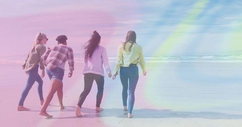 Group of Friends Strolling Barefoot on Sunny Beach Day