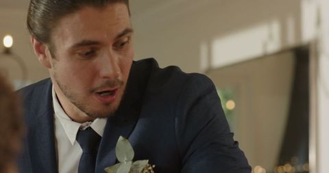 Groom Excitedly Popping Champagne on Wedding Day Celebration
