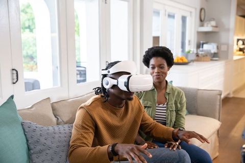 Couple Experiencing Virtual Reality Technology in Modern Living Room