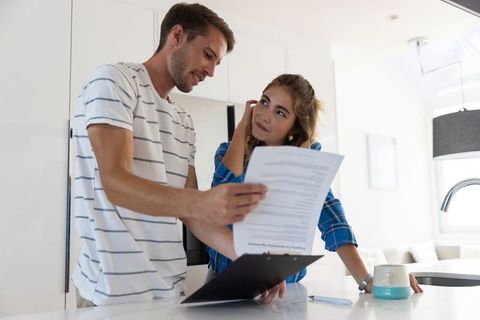 Couple Reviewing Document in Bright Modern Kitchen