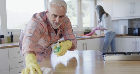 Middle-Aged Couple Cleaning Modern Kitchen - Download Free Stock Images Pikwizard.com