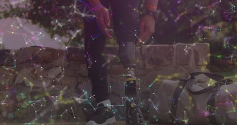 Athlete Adjusting Prosthetic Leg Outdoors with Digital Network Overlay