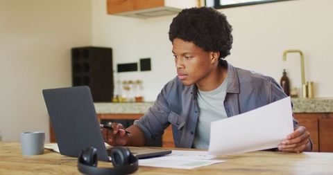Focused African American Man Working Remotely on Laptop at Home