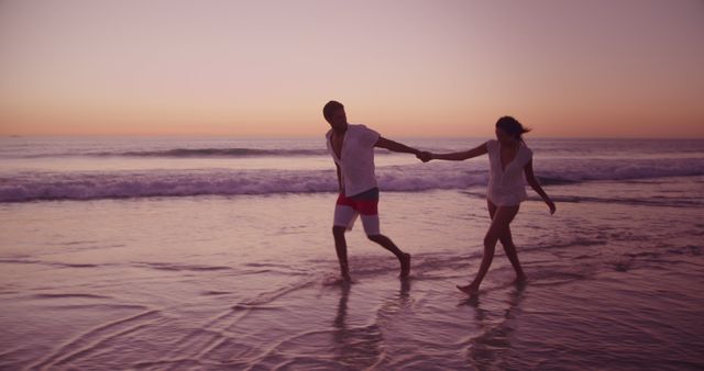 Couple Walking Along Beach at Sunset Holding Hands - Download Free Stock Images Pikwizard.com