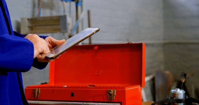 Technician Using Tablet with Open Toolbox in Workshop - Download Free Stock Images Pikwizard.com