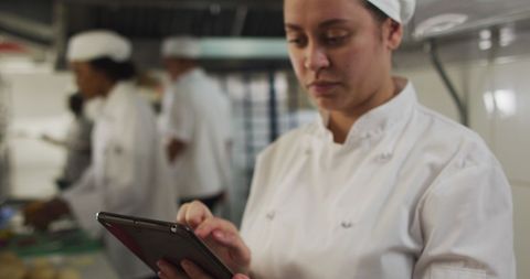 Professional Chef Using Digital Tablet in Restaurant Kitchen