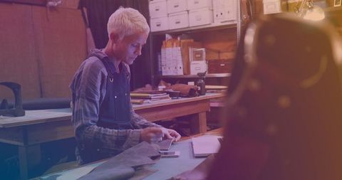 Woman expertly repairing smartphone in artisan workshop