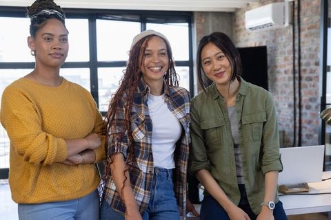 Empowered Diverse Female Coworkers in Modern Office Setting