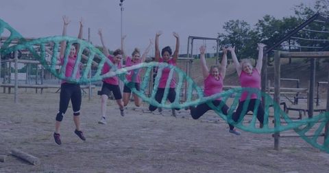 Group of Women Jumping on Outdoor Obstacle Course with DNA Model