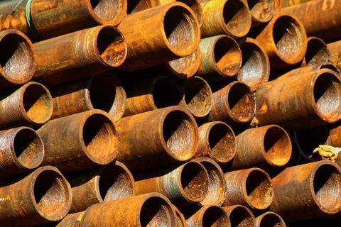 Stack of weathered rusty industrial pipes