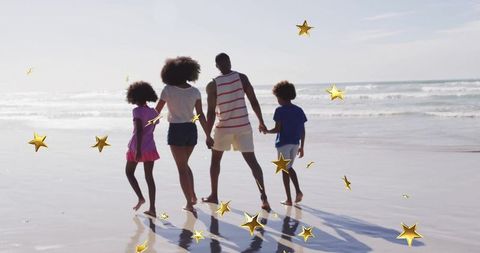 Family strolling beach with golden stars enhancing togetherness