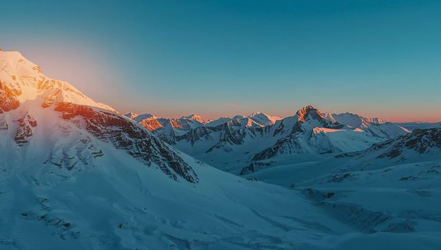 Sunrise Majesty Over Snow-Capped Mountain Peaks