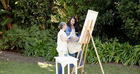Chinese Art Teacher Guides Student in Outdoor Painting Session