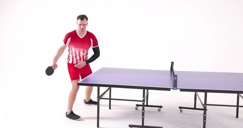 Male Athlete Playing Ping Pong Intense Game Pose