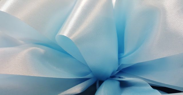 Close-Up of Light Blue Satin Fabric Flowing Smoothly - Download Free Stock Photos Pikwizard.com