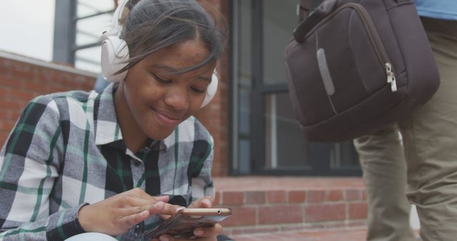 Teen Girl Using Smartphone with Headphones Outdoors - Download Free Stock Images Pikwizard.com