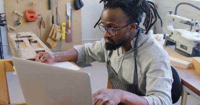 Craftsman using laptop in woodworking workshop - Download Free Stock Images Pikwizard.com