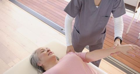 Senior Woman Receiving Arm Therapy from Physiotherapist