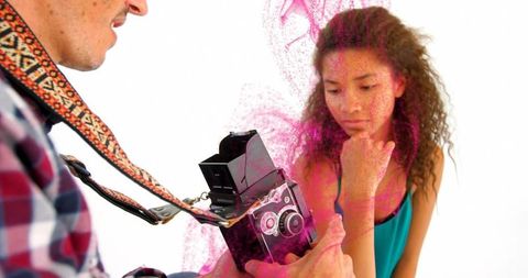 Photographer with Vintage Camera Capturing Model in Artistic Photo Shoot