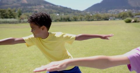 Child Stretching Arms Outdoors During School Activity