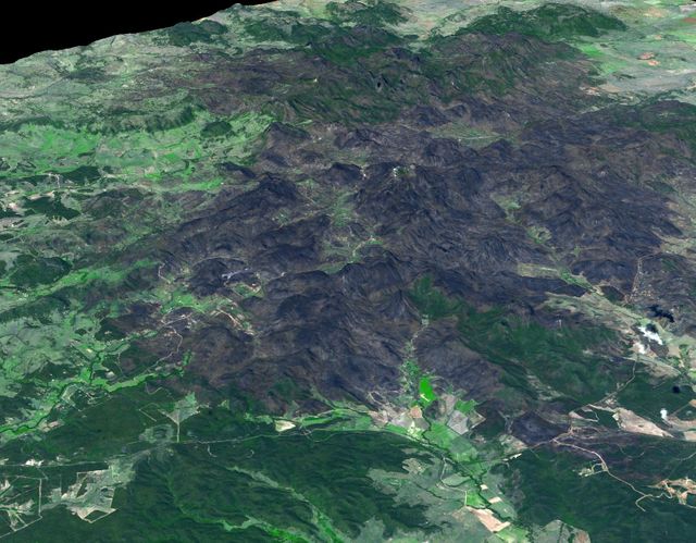This 3-D view was created from data acquired Feb. 4, 2013 by NASA Terra spacecraft showing a massive wildfire which damaged Australia largest optical astronomy facility, the Siding Spring Observatory.