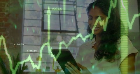 Businesswoman analyzing stock data on tablet in modern office