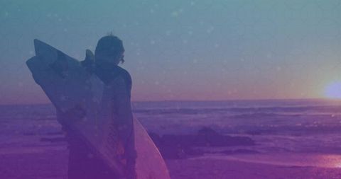 Surfer holding surfboard at sunset with vibrant tone overlay