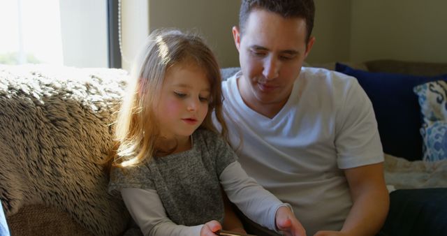 Father and Daughter Spending Time Together on Cozy Couch - Download Free Stock Images Pikwizard.com