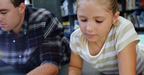 Parent and child reading together in cozy library setting