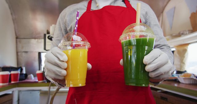 Vendor in Red Apron Holding Fresh Juices at Food Truck - Download Free Stock Images Pikwizard.com