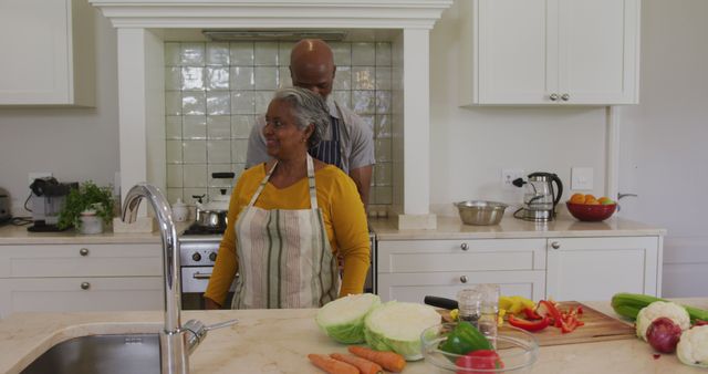 Senior couple bonding while cooking together in the kitchen - Download Free Stock Images Pikwizard.com