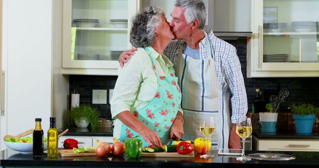 A senior Caucasian couple shares a loving kiss while preparing a meal together in a home kitchen, with copy space. Their affectionate moment amidst the culinary setting suggests a long-standing bond and the joy of shared activities.