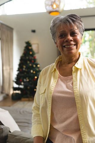 Joyful Senior African American Woman in Festive Living Room for Christmas