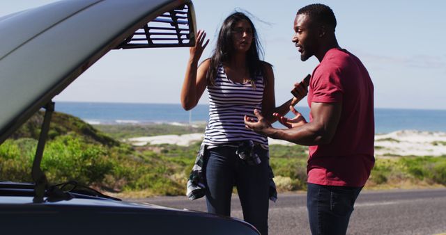 African american arguing with each other while trying to fix the car on road. road trip travel and adventure concept