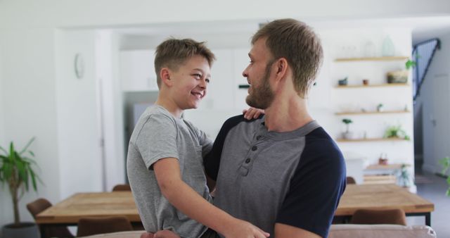 Happy Father Holding Smiling Son in Modern Home - Download Free Stock Images Pikwizard.com