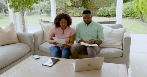 Mature Couple Managing Finances at Home with Technology